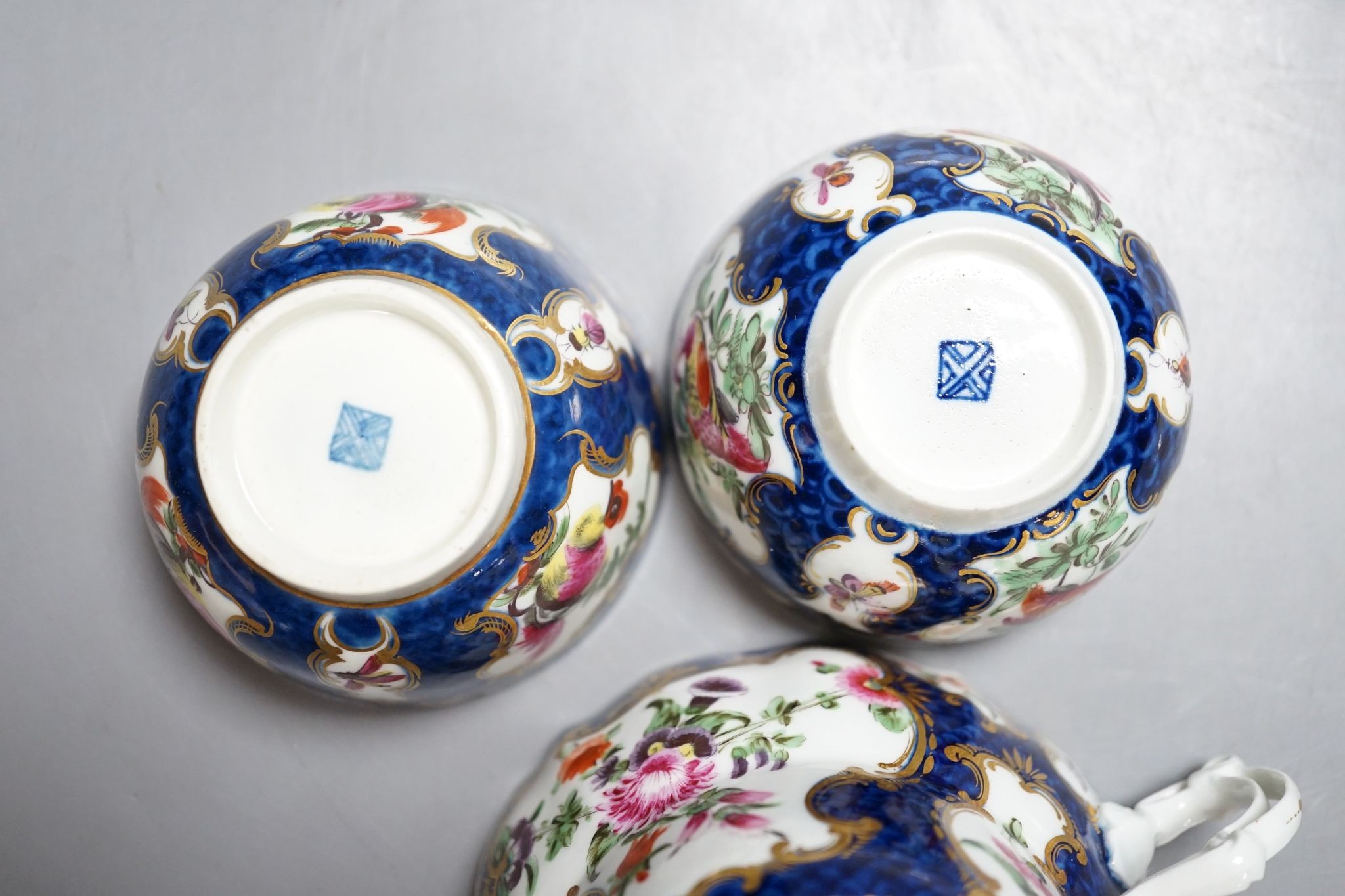 A Worcester scale blue chocolate cup and saucer and a pair of similar tea bowls and saucers, circa 1775